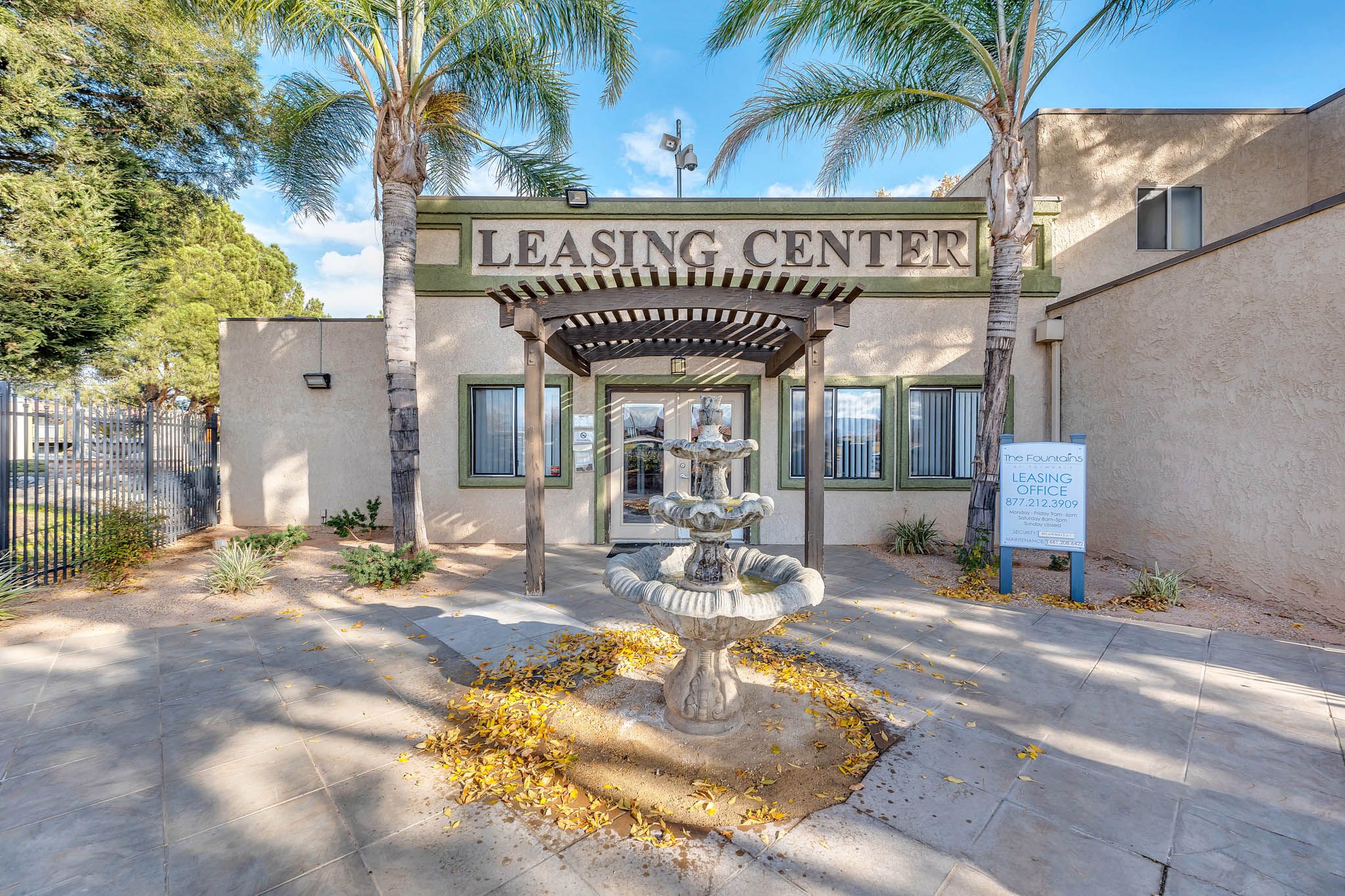 the leasing center entrance with a fountain in front of the building